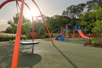 A playground with slides and other toys in a park